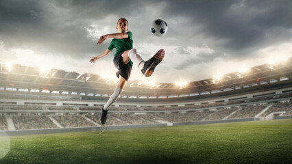 Boy in green jersey executes a dramatic flying kick with a soccer ball on a 3D stadium field. Concept of educational promotion for youth sports development