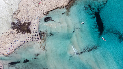 Drone shots of Balos Lagoon capture its breathtaking blend of turquoise waters, white sand, and...