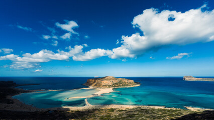From the viewpoint above Balos Lagoon, the sweeping view reveals turquoise waters, the narrow sandy...