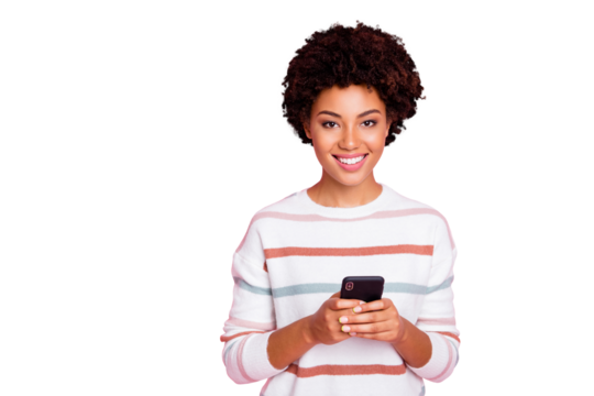 Photo of pretty dark skin curly lady holding telephone addicted to internet reposts and comments wear white striped pullover isolated pastel pink color background