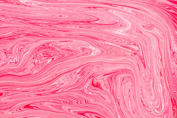 Acrylic paint swirling vibrant pink pattern background