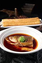 Wild bighead carp head braised in Beijing-style sauce with large fried dough sticks