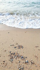 Pebbles on beach with gentle waves
