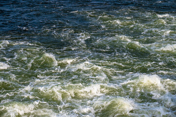 Aerial view of sea waves. Blue water background.