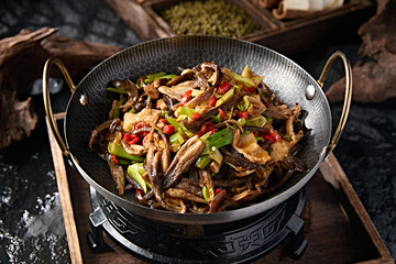 Chinese food: pork belly with pepper and garlic sprouts, tea tree mushroom