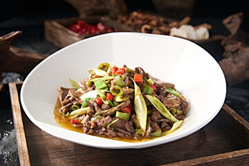 Sichuan style stir-fried pork liver with rice pepper and garlic sprouts