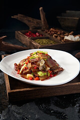 Chinese Sichuan style stir-fried pork with garlic sprouts