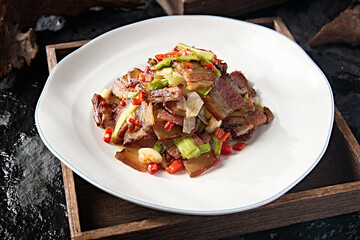 Chinese Sichuan style stir-fried pork with garlic sprouts