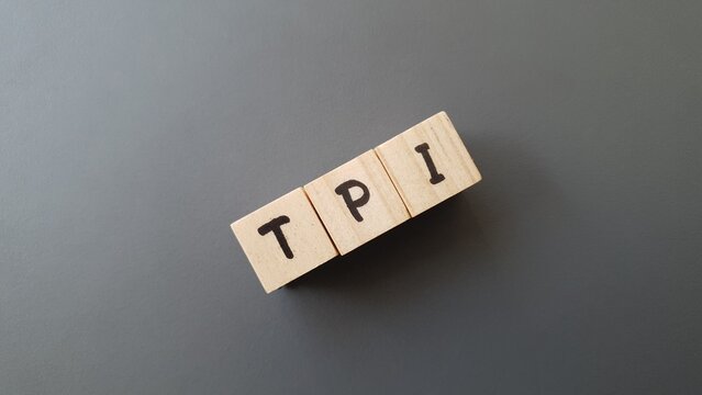 TPI acronym made of wooden letter cubes on dark background. Total Pensi&oacute;n Individual (Total Individual Pension)