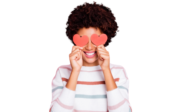 Photo of pretty dark curly skin lady holding in hands little red paper hearts hiding flirty eyes wear white striped pullover isolated pastel pink color background