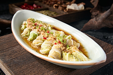 Chinese food: Steamed cabbage and pork rolls with garlic, rice and pepper