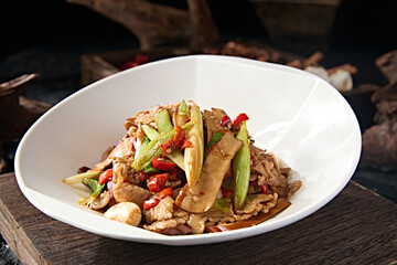 Chinese food stir-fried pork belly with rice pepper, garlic sprouts, garlic and dried tofu