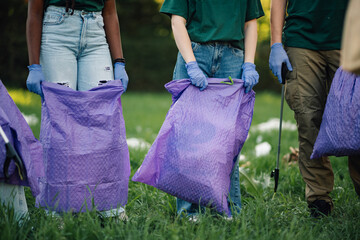 Volunteers collecting garbage in park cleanup event