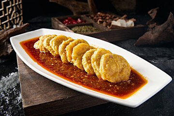 Chinese food Tianjin style food fried lotus root with minced pepper sauce and fried meat stuffing wrapped in noodles