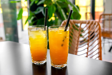 Orange fresh cool juice cocktail in glass on table in cafe,bar. Tropical drink for summer...