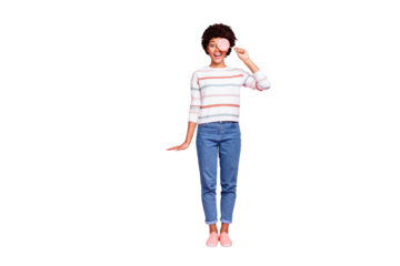 Full length body size photo of childish girlish curly wavy trendy stylish girlfriend holding candy wearing jeans denim footwear white striped sweater isolated over pink pastel color background