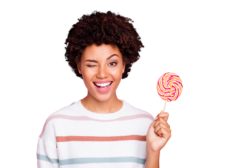 Photo of cheerful cute nice charming sweet girl holding candy with hands wearing white striped sweater blinking isolated over pastel color background