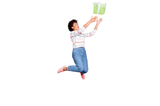 Full length body size photo of jumping pretty childish youngster stretching to receive gift box in jeans denim striped sweater with excited facial expression isolated pastel color background