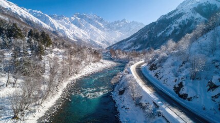 Winding snow - covered mountain road and clear blue river, showing the enchanting winter beauty of pure nature.