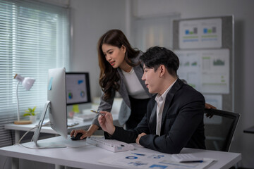 woman and a man are working together at a computer