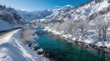 Winding snow - covered mountain road and clear blue river, showing the enchanting winter beauty of pure nature.