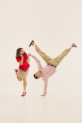 A dynamic lindy hop duo performs an energetic retro dance move. Concept of 1940s swing dance...