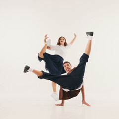 Energetic lindy hop dancers perform dynamic retro dance moves in stylish vintage attire. Concept of vibrant 1940s dance culture revival.