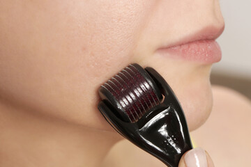 Facial massage with microneedle dermaroller for the treatment of scars, wrinkles and for facial...