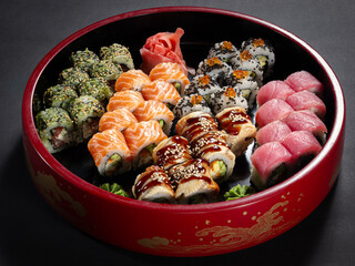A red bowl of assorted sushi rolls