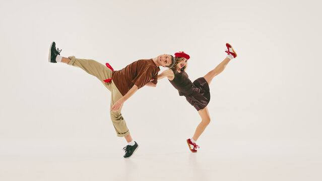 Energetic dancers perform a dynamic lindy hop routine with retro style and vibrant enthusiasm. Concept of vintage dance revival and cultural expression.