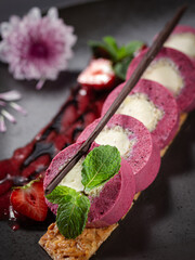 A dessert with a strawberry and mint garnish on top
