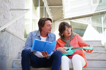 Elderly teacher and student learning outdoors