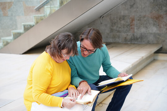 Elderly teacher and student learning outdoors together