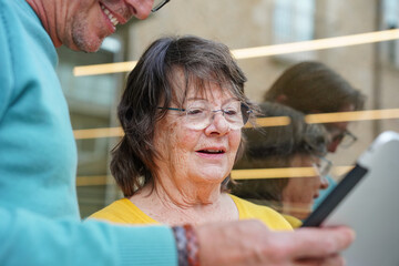 Elderly teacher and student learning together outdoors