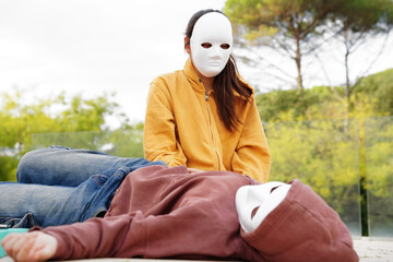Teenagers wearing masks in drama class activity