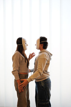 Teenagers in drama class with masks