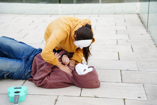 Teenagers practicing drama with masks in class