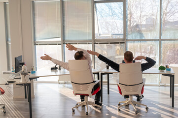 Two Caucasian men having fun at work. 