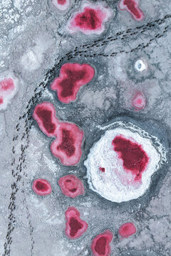 Aerial view of vibrant red salt ponds in La Puna