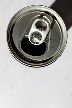 Top view of an open soda can on a textured background