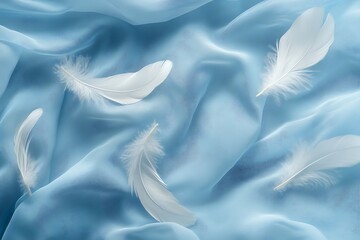 Fototapeta premium Serene white feathers on flowing light blue silk fabric; ethereal, delicate mood.