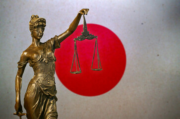 Lady Justice before a flag of Japan