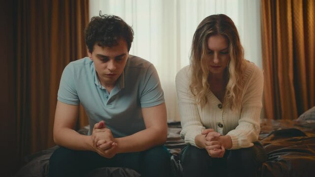 couple quarreling concept of family relationship problems divorce, man and woman cry sitting at bed resentment towards each other in dark bedroom. guy cheated on girl. betrayal jealousy broken heart