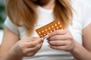 Contraceptive Pills Preparation. A woman preparing to take her birth control pills.