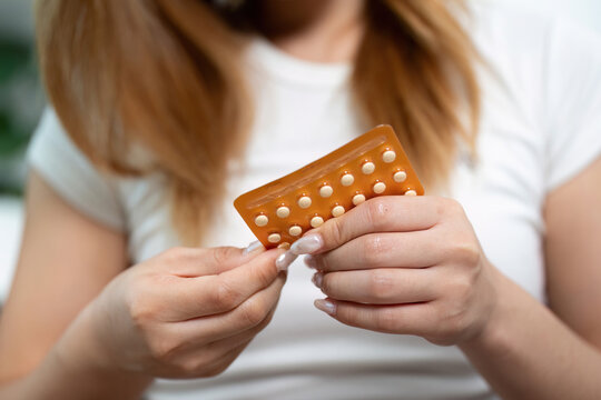 Contraceptive Pills Preparation. A woman preparing to take her birth control pills.