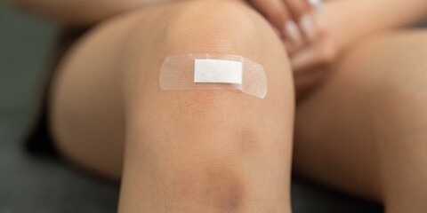 Injury Care. Close-up of a knee with a bandage applied for protection.