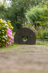 Old Millstone Surrounded by Summer Blooms