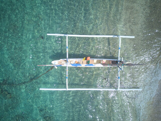 Parked typical Indonesian sailing trimaran boat. View from drone.