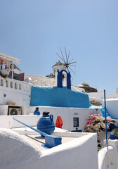 Whitewashed houses and windmill in Oia on Santorini island, Cyclades, Greece