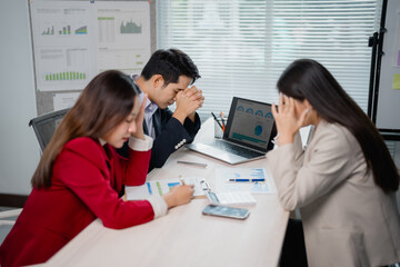 Stressed business team having headache while working on company's financial strategy, marketing...